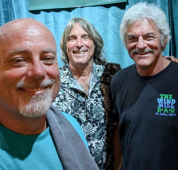 Kevin Leahy, one of the owners of Coastal Isles Wine Bar, standing with musicians Andy Mauck and Bill Fredericks